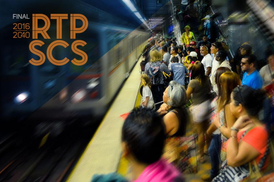 Crowded subway platform with a train arriving.