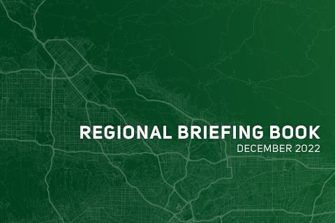 Green cover with white text "Regional Briefing Book December 2022" over a map pattern.